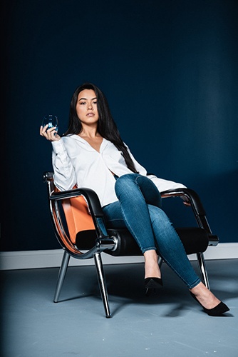 Woman Sitting on a Chair With a Glass in Hand - Model Headshots by Headshot Photographer in Minneapolis
